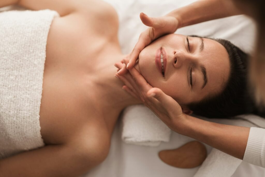 Crop anonymous woman doing facial procedure to smiling female client